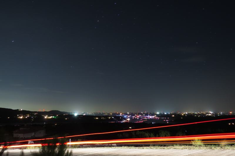 Lake Travis and the surrounding hills at night